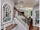 The stairway includes a wood banister, an arched window and a view of the living room at 730 Pear Grove Pl, Marietta, GA 30066