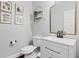 Powder room features a modern vanity, speckled white countertop, and framed art at 2471 Bridlewood Se Dr # 8, Atlanta, GA 30339