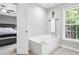 Bathroom features a large tub with a view of the bedroom through an open doorway at 2471 Bridlewood Se Dr # 8, Atlanta, GA 30339