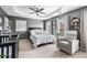 Bedroom with tray ceiling, a crib, and a comfortable rocking chair next to the window at 2471 Bridlewood Se Dr # 8, Atlanta, GA 30339