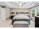 Primary bedroom with a tray ceiling, large bed, bedside tables, and natural light at 2471 Bridlewood Se Dr # 8, Atlanta, GA 30339