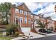 Attractive brick townhomes featuring attached garages, well-manicured lawns, and patriotic decor at 2471 Bridlewood Se Dr # 8, Atlanta, GA 30339