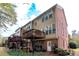 View of the building featuring multiple decks, a well-kept yard and brick facade at 2471 Bridlewood Se Dr # 8, Atlanta, GA 30339