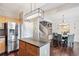 Open concept kitchen flowing into a dining area with a view of the staircase at 2471 Bridlewood Se Dr # 8, Atlanta, GA 30339