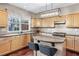 Well-lit kitchen with wooden cabinets, dark countertops, and a central island with seating at 2471 Bridlewood Se Dr # 8, Atlanta, GA 30339