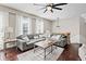 Bright living room with a large sectional sofa, hardwood floors, and stylish decor at 2471 Bridlewood Se Dr # 8, Atlanta, GA 30339