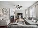 Inviting living room with a fireplace, modern ceiling fan, and comfortable seating arrangement at 2471 Bridlewood Se Dr # 8, Atlanta, GA 30339