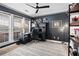 Home office featuring dark walls, a ceiling fan, and large windows at 2471 Bridlewood Se Dr # 8, Atlanta, GA 30339