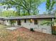 Back exterior of home showing white painted brick and fenced yard at 5626 Noblett Sw Rd, Stone Mountain, GA 30087
