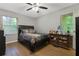 Inviting bedroom with hardwood floors, ceiling fan, and windows offering great natural lighting at 5626 Noblett Sw Rd, Stone Mountain, GA 30087