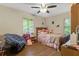 Sweet bedroom featuring hardwood floors, windows, and soft decor for a cozy, comforting space at 5626 Noblett Sw Rd, Stone Mountain, GA 30087