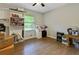 Cozy bedroom with hardwood floors, a ceiling fan, and an abundance of shelves and storage options at 5626 Noblett Sw Rd, Stone Mountain, GA 30087