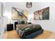 Modern bedroom featuring unique artwork, side tables with lamps, and cozy bedding at 567 Ponce De Leon Ne Ave # 415, Atlanta, GA 30308