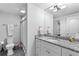 Well-lit bathroom with a granite countertop, white cabinets and modern fixtures at 1477 Village Park Ne Ct, Atlanta, GA 30319