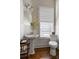 Cozy powder room featuring classic fixtures, decorative wallpaper, and natural light at 1477 Village Park Ne Ct, Atlanta, GA 30319