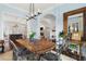Stylish dining room with a wooden table, metal chairs, and a modern chandelier at 1477 Village Park Ne Ct, Atlanta, GA 30319