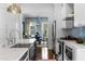 Bright white kitchen with stainless steel appliances, marble countertops, and breakfast area view at 1477 Village Park Ne Ct, Atlanta, GA 30319