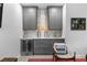 Stylish living room features a built in bar with a wine fridge, cabinets, and open seating at 1477 Village Park Ne Ct, Atlanta, GA 30319