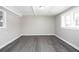 Finished basement featuring gray vinyl flooring, paneled walls, and natural light at 1722 Johnston Nw Trl, Kennesaw, GA 30152