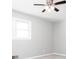Bright bedroom with a ceiling fan, large window, and soft neutral carpet at 1722 Johnston Nw Trl, Kennesaw, GA 30152