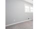 Neutrally decorated bedroom featuring a large window and plush gray carpet at 1722 Johnston Nw Trl, Kennesaw, GA 30152