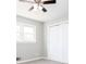 Neutral bedroom with fan, closet, and double windows at 1722 Johnston Nw Trl, Kennesaw, GA 30152