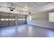 Spacious garage with painted floor, overhead lighting, and multiple garage doors at 1722 Johnston Nw Trl, Kennesaw, GA 30152