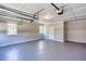 Spacious garage with painted floor, overhead lighting, and natural light from a window at 1722 Johnston Nw Trl, Kennesaw, GA 30152
