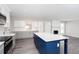 Open concept kitchen with stainless appliances, white cabinets, gray counters, and a blue center island at 1722 Johnston Nw Trl, Kennesaw, GA 30152