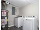 Laundry room showing a hot water heater, newer washer and dryer, and painted walls at 1722 Johnston Nw Trl, Kennesaw, GA 30152