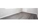 Neutral room showing gray wood-look flooring, white trim, and a white entry door at 1722 Johnston Nw Trl, Kennesaw, GA 30152