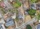 An aerial view of a charming home with a driveway, gray roof, and a beautiful yard surrounded by mature trees at 1815 Monroe Ne Dr, Atlanta, GA 30324