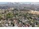 An aerial shot of a neighborhood with tree lined streets and a skyline view in the distance at 1815 Monroe Ne Dr, Atlanta, GA 30324
