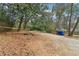 Large wooded lot with gravel area, deck, and trash bins at 1815 Monroe Ne Dr, Atlanta, GA 30324