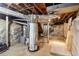 Basement features concrete flooring, stone foundation, water heater, and exposed beams at 1815 Monroe Ne Dr, Atlanta, GA 30324