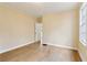 Bedroom featuring a window, wood floors, painted yellow walls, and a white door at 1815 Monroe Ne Dr, Atlanta, GA 30324