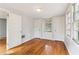 Bright bedroom showcasing hardwood floors, two closets, a built-in seat, and fresh paint at 1815 Monroe Ne Dr, Atlanta, GA 30324