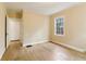 Bedroom featuring a window, wood floors, painted yellow walls, and a white door at 1815 Monroe Ne Dr, Atlanta, GA 30324