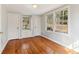 Bedroom boasts hardwood floors, neutral paint, and natural light from the three windows at 1815 Monroe Ne Dr, Atlanta, GA 30324