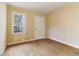 Bedroom with a large window, wood floors, painted yellow walls, and a white door at 1815 Monroe Ne Dr, Atlanta, GA 30324