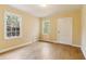 Bedroom with hardwood floors, two windows that bring in natural light, and yellow walls with white trim at 1815 Monroe Ne Dr, Atlanta, GA 30324