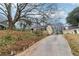 View of the home up a long driveway with trees surrounding the property at 1815 Monroe Ne Dr, Atlanta, GA 30324