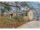 View of the home up a long driveway with trees surrounding the property at 1815 Monroe Ne Dr, Atlanta, GA 30324