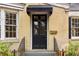 Close up of front door with awning and black railing on stoop at 1815 Monroe Ne Dr, Atlanta, GA 30324