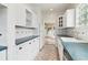 Cozy kitchen with white cabinetry and stainless steel appliances; view towards backyard at 1815 Monroe Ne Dr, Atlanta, GA 30324
