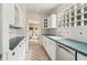 Well-lit kitchen with white cabinets, a dark countertop, and view to a backyard through double doors at 1815 Monroe Ne Dr, Atlanta, GA 30324