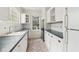 Bright kitchen featuring white cabinets, dark countertops, and stainless steel appliances at 1815 Monroe Ne Dr, Atlanta, GA 30324