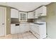 Kitchen featuring white cabinets and appliances, tiled floor, and natural light from the window at 1815 Monroe Ne Dr, Atlanta, GA 30324