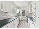 Cozy kitchen featuring white cabinetry, a tile backsplash, and stainless steel appliances at 1815 Monroe Ne Dr, Atlanta, GA 30324