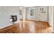 Living room featuring gleaming hardwood floors, natural light, and a vintage wall-mounted heater at 1815 Monroe Ne Dr, Atlanta, GA 30324
